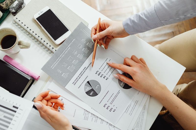 Recruiter reviewing an application and supporting candidate details at a desk