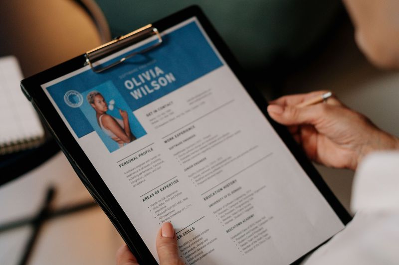 Recruiter reviewing an applicant resume on a clipboard during screening
