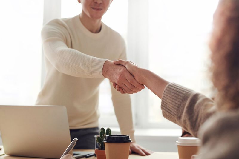 Client and recruiter shaking hands over a successfully completed placement