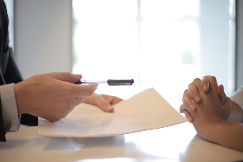 Client signing a direct hire placement agreement with a recruiter
