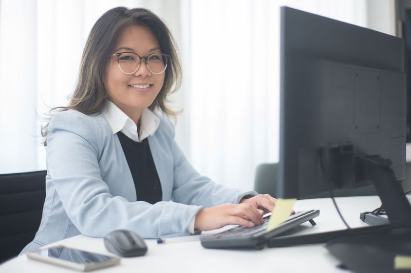 Temporary administrative employee working at her desk on assignment